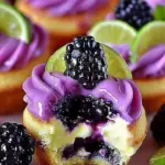 Delicious cheesecake cupcakes topped with blackberry and lime zest