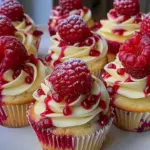 Divine Raspberry Cheesecake Cupcakes topped with fresh raspberries and creamy frosting