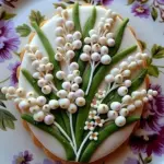 Lily of the Valley sugar cookies beautifully decorated with floral designs.