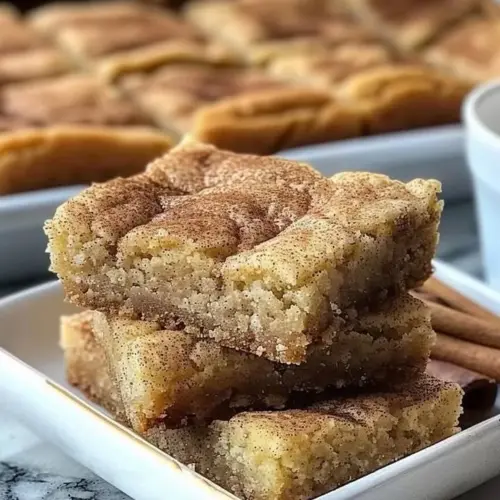 Chewy Snickerdoodle Cookie Bars fresh out of the oven, sprinkled with cinnamon sugar.