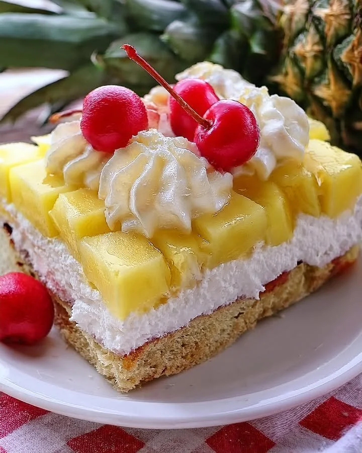 Heavenly Pineapple Cake topped with fresh fruit and whipped cream