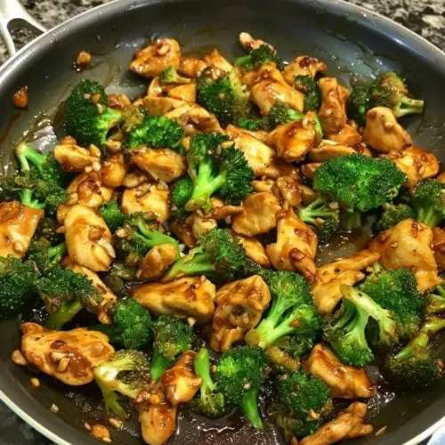 Plate of Szechuan Chicken and Broccoli garnished with sesame seeds